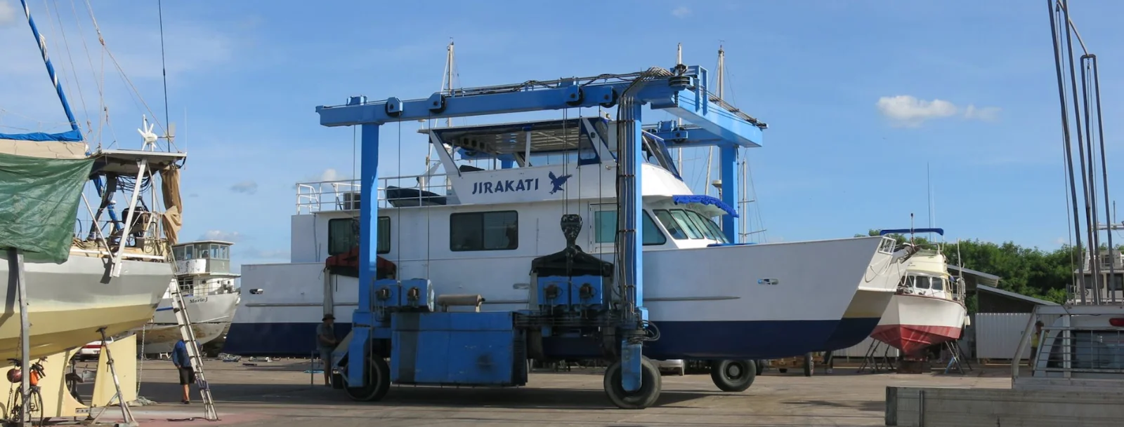 A vessel in the blue travel lift at Spot On Marine’s Darwin boatyard